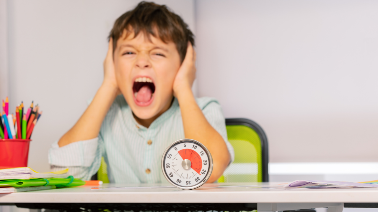 Little Boy Covering His Ears At ABA Therapy