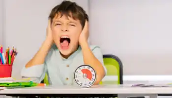 Little Boy Covering His Ears At ABA Therapy